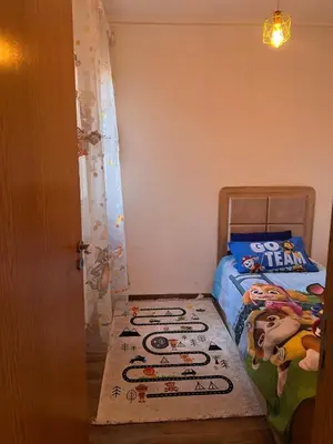 a bedroom with a bed with a mickey mouse rug on the floor at New, quiet and comfortable in Marrakech