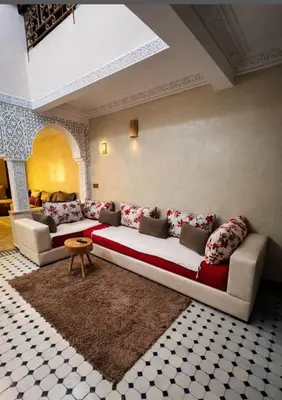 a living room with a large couch in a room at Très bel Riad avec piscine au cœur de Marrakech in Marrakech