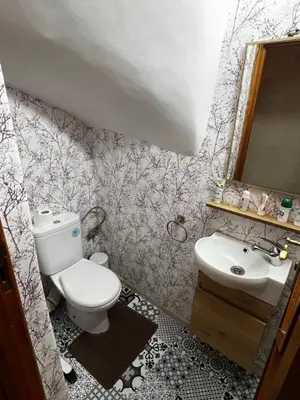 a bathroom with a toilet and a sink and a mirror at Très bel Riad avec piscine au cœur de Marrakech in Marrakech