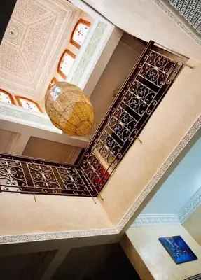 a room with a ceiling with two baskets on it at Très bel Riad avec piscine au cœur de Marrakech in Marrakech