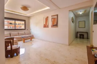 a living room with a couch and a table at Heart of Marrakech - Hivernage 2 bedroom apartment in Marrakech