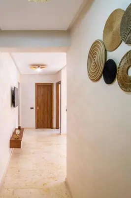 a hallway with hats hanging on a wall at Heart of Marrakech - Hivernage 2 bedroom apartment in Marrakech