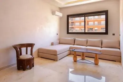 a living room with a couch and a chair at Heart of Marrakech - Hivernage 2 bedroom apartment in Marrakech