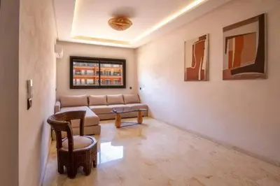 a living room with a couch and a table at Heart of Marrakech - Hivernage 2 bedroom apartment in Marrakech