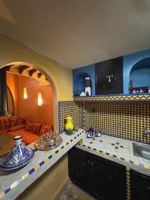 a living room with a couch and a table at Authentic Moroccan Riad with a pool and a rooftop in Marrakech