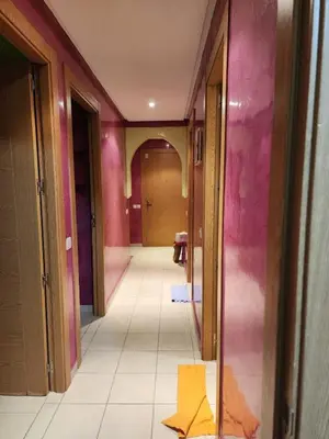 a hallway with pink walls and a tile floor at Comfortable apartment for families in Marrakech