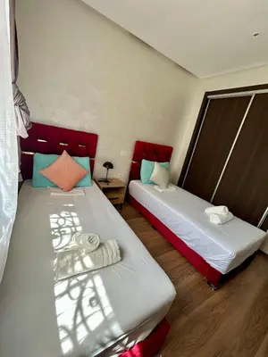 two beds in a room with red headboards at New! Nouveau! Le Cocon familial in Marrakech