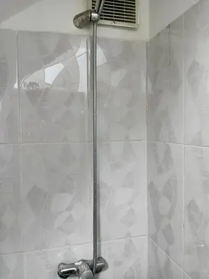 a shower stall in a bathroom with a shower at Le Palmier de Guéliz in Marrakech