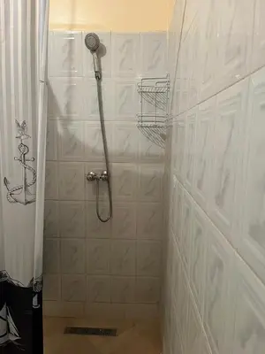 a shower with a shower head in a bathroom at Beautiful, very quiet apartment in Marrakech