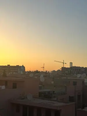 a view of a city at sunset with buildings at Kueerland in Marrakech