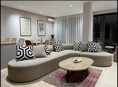 a living room with a couch and a table at Villa Dar Moumoune à Marrakech, piscine chauffée en option in Sraghna