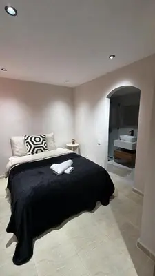a bedroom with a bed with two towels on it at Villa Dar Moumoune à Marrakech, piscine chauffée en option in Sraghna