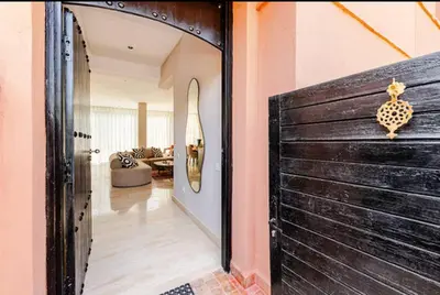 a wooden door in a room with a living room at Villa Dar Moumoune à Marrakech, piscine chauffée en option in Sraghna