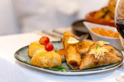 a plate of food with fish and other foods at Dar Bonita in Marrakech