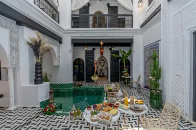 a villa with a swimming pool in the middle at Dar Bonita in Marrakech