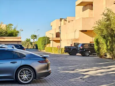 a car parked in a parking lot next to a building at Duplex Premium 3 Suites, Style Villa, Terrasse & Accès direct piscine, Oliver Palm Resort Marrakech in Marrakech