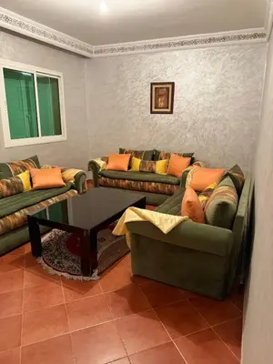 a living room with two couches and a coffee table at The cozy Den in Marrakech