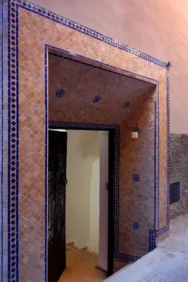 a doorway into a room with a tiled wall at Riad Porte Royale in Marrakech