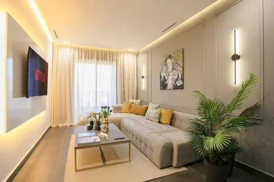 a living room with a couch and a table at Luxury Designer Apartment Central Marrakech in Marrakech