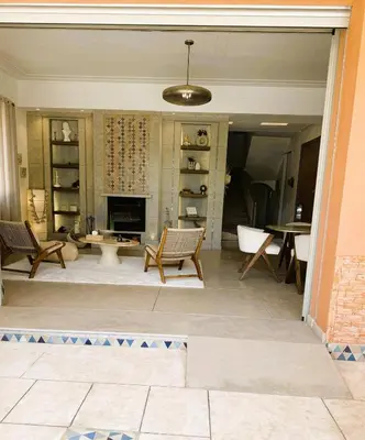 a living room with chairs and a fireplace at Villa Marrazen, lovely villa -housestaff included in Marrakech