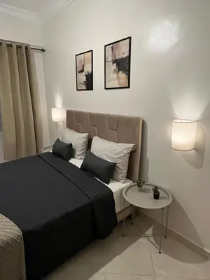a bedroom with a bed and a small table at GZ Loft in Marrakech