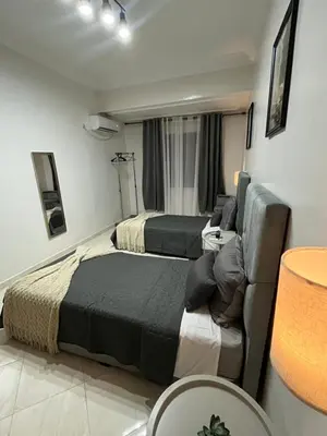 a bedroom with two beds and a couch at GZ Loft in Marrakech