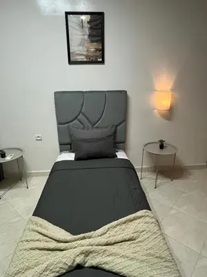 a bedroom with a black bed with two tables at GZ Loft in Marrakech