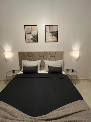 a bedroom with a large bed with three pictures on the wall at GZ Loft in Marrakech