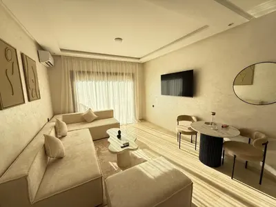 a living room with a couch and a table at Modernes Apartment in Top-Lage Guéliz, Marrakech 2 in Marrakech