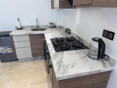 a kitchen with a stove and a sink at Modernes Apartment in Top-Lage Guéliz, Marrakech 2 in Marrakech