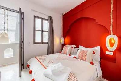 a bedroom with a red headboard and a white bed at Stylish and Exclusive Riad Saada with Pool and free Breakfast in Marrakech