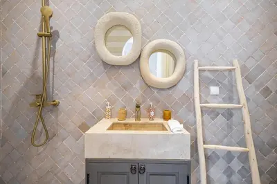 a bathroom with a sink and two mirrors on the wall at Stylish and Exclusive Riad Saada with Pool and free Breakfast in Marrakech
