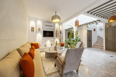 a living room with a couch and a table at Stylish and Exclusive Riad Saada with Pool and free Breakfast in Marrakech