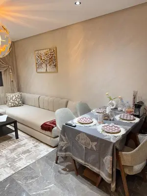 a living room with a table and a couch at Appartement à Marrakech in Marrakech