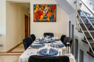 a dining room with a long table with blue plates at Marrakech Centre Ville Rooftop & Espace Fitness in Marrakech