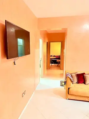 a living room with a couch and a flat screen tv at N9 Parfait Top Près De Gueliz in Marrakech