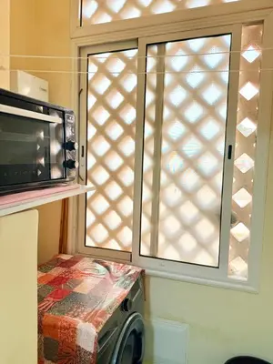 a kitchen with a microwave and a window at N9 Parfait Top Près De Gueliz in Marrakech