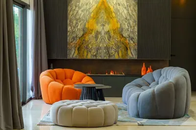 two orange chairs and a table in a living room at Villa R, luxury, gym, private pool in Marrakech