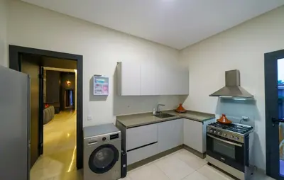 a kitchen with a stove and a dishwasher at Villa R, luxury, gym, private pool in Marrakech