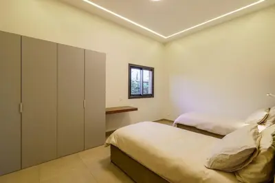 a bedroom with two beds and a window at Villa R, luxury, gym, private pool in Marrakech