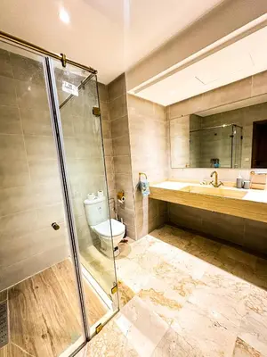 a bathroom with a shower and a toilet and a sink at Chez Mams Guest House - Private Rooms in a Resort-Style Apartment Complex in Marrakech