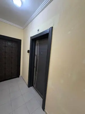 a black garage door in a room with a tile floor at Les jardins de Carlota in Marrakech