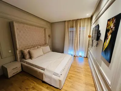 a bedroom with a large white bed in a room at Perle garden in Marrakech