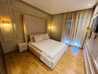 a bedroom with a large white bed in a room at Perle garden in Marrakech