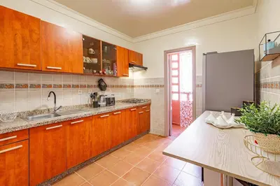 a kitchen with wooden cabinets and a stainless steel refrigerator at Chic & Calm in Marrakech, Ideal for Digital Nomads in Marrakech