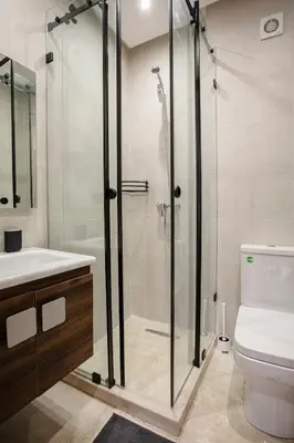 a bathroom with a shower and a sink and a toilet at Le Nomadic Chic Piscine Privée in Marrakech