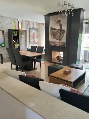a dining room with a table and chairs at Pavillon Luxe - Jardin de l'Atlas - Golf & Waky in Sraghna