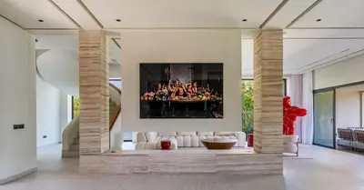 a living room with a fireplace with a painting on the wall at Villa Simone in Marrakech