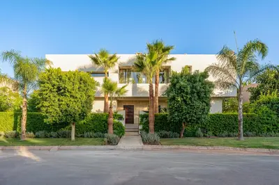 a building with palm trees in front of it at Villa Simone in Marrakech