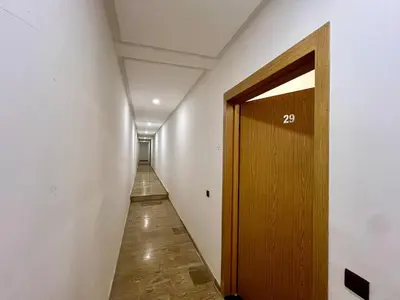 a hallway with a wooden door in a room at Appartement cosy et moderne familial in Marrakech